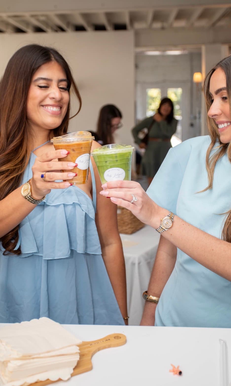 Guests holding iced coffee and matcha drinks from Reyes Coffee & Catering